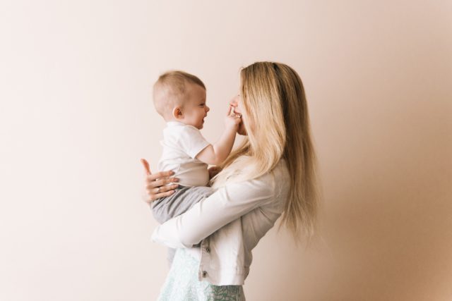Mother playing with baby boy, happy family having fun indoor, cheerful sweet kid portrait, mom and child, healthy toddler, lifting throwing carrying holding up game